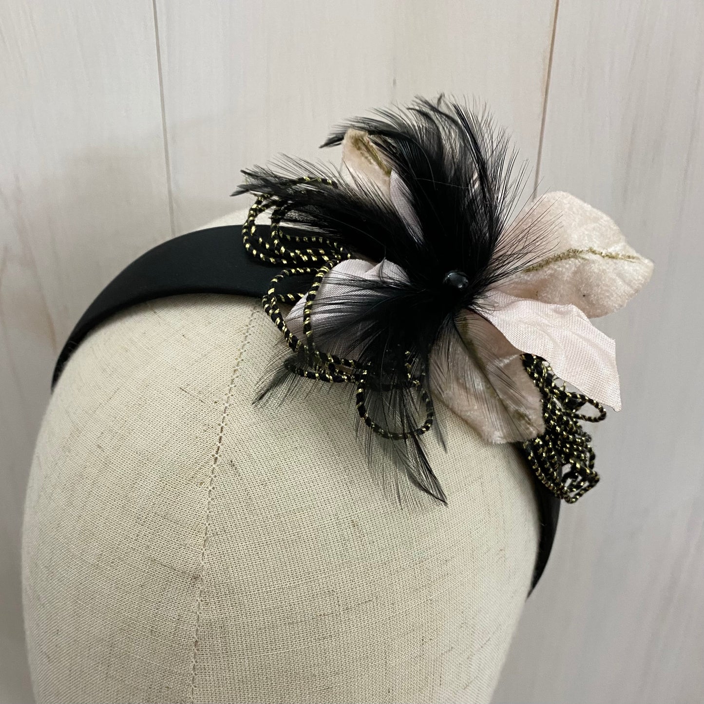 black headband with flower and feathers