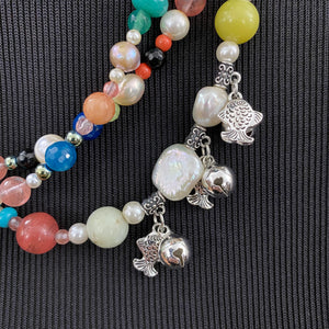 collana lunga in perle e pietre dure con charm sonagli e pesci